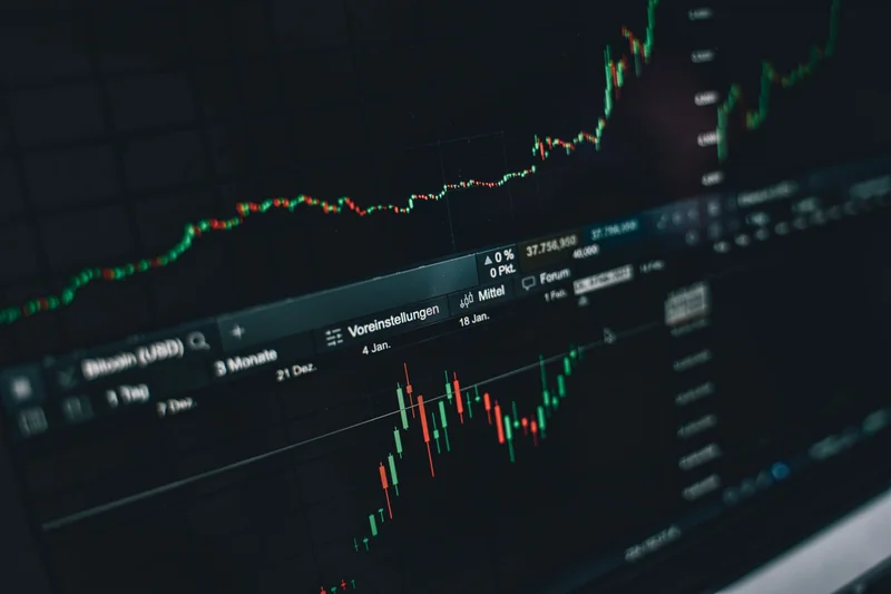 Close-up of a digital market analysis display showing Bitcoin and cryptocurrency price trends.